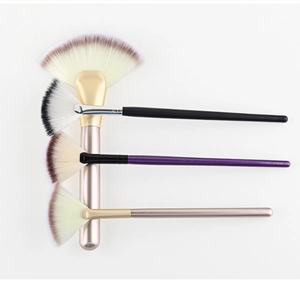 Detail of four fan makeup brushes in various sizes with soft bristles and colorful handles