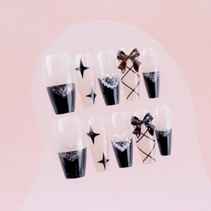 Dark gothic press-on nails with black bows, glitter hearts, and pearls in 10-piece set