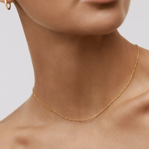 Minimalist 925 sterling silver gold necklace and earrings set shown on model