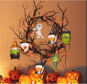 Detail of wooden Halloween gnomes and spooky characters hanging on a lit wreath