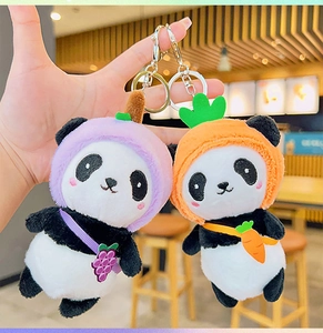 Detail of cute panda plush keychain in purple grape and orange carrot fruit outfits