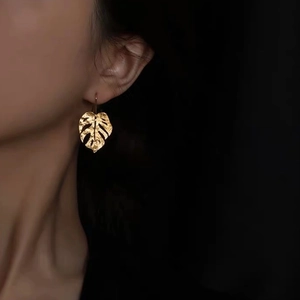 Elegant gold monstera leaf earrings with hammered metal texture for women