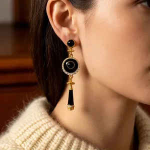 Vintage art deco drop earrings in gold with black circular charms and pave zircon accents