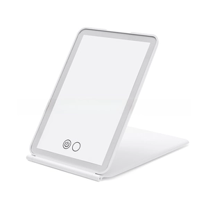 Macro shot of white LED travel mirror with adjustable folding stand and touch controls