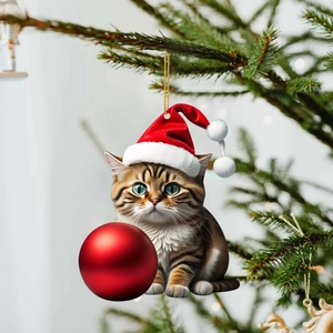 Close-up of a brown tabby cat acrylic ornament hanging on a festive Christmas tree branch