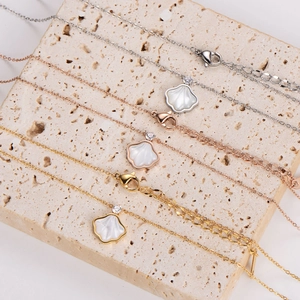 Elegant minimalist shell necklaces in silver, rose gold, and gold finishes on stone