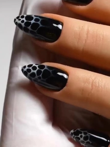 Almond-shaped black press-on nails with white 3D bubble texture and leopard pattern
