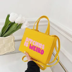 Bright yellow PU leather crossbody bag with bold purple slogan print and top handle