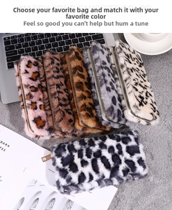 Detail of diverse leopard print plush pouches with gold zipper closure and soft faux fur texture