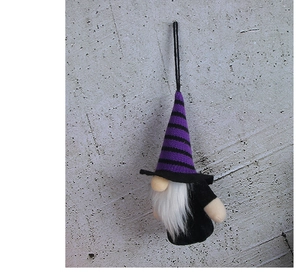 Close-up of Halloween gnome ornament with purple striped hat and long white beard