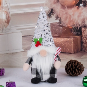 Christmas gnome plush with white sequin hat and black-white plaid body in festive home setting