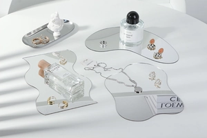 Close-up of irregular acrylic mirrors and jewelry on a professional photo prop tray