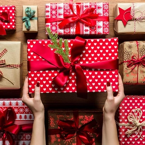 Close-up of assorted festive gift boxes with heart and snowflake patterns on wood