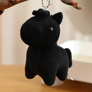 Close-up of a small black plush pony keychain with soft fabric and silver ball chain