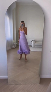 Detailed view of lavender purple spaghetti strap maxi dress with ruffled hem and sleek silk finish