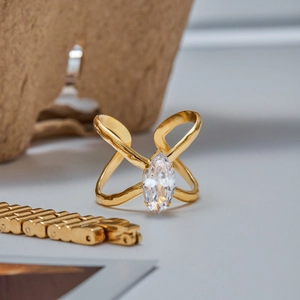 Macro detail of gold plated marquise cut zircon ring with a double cross band design