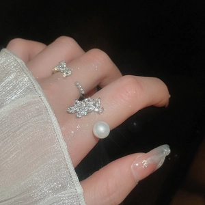 Detail of silver rings with zircons leaf design and elegant white pearl on hand