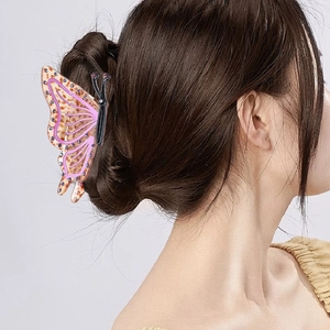 Acetate butterfly hair claw clip with purple rhinestones and dark leopard print pattern