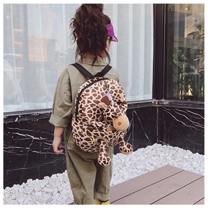 Toddler backpack featuring giraffe print and 3D plush animal toy on outdoor background