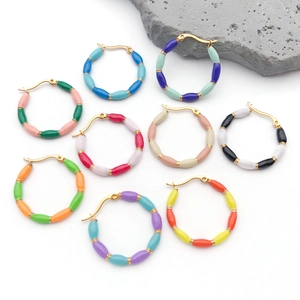 Detail view of colorful bamboo style enamel earrings in various vibrant color combinations