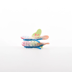Macro detail of butterfly hair claw with colorful marble texture and sparkling rhinestones