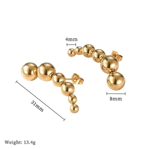 Detailed view of curved gold titanium earrings showing 31mm length and bead dimensions