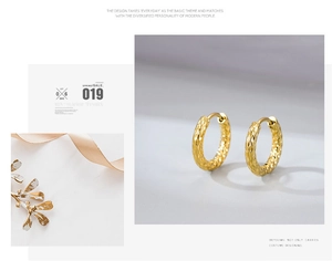 Detailed close-up of golden hammered texture hoop earrings with elegant metal reflections