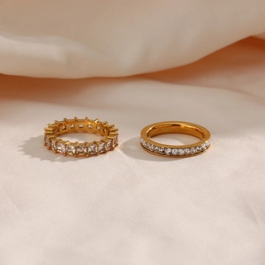 18K gold plated eternity rings with square-cut cubic zirconia on peach silk fabric