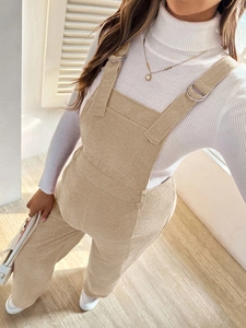 Detail of beige corduroy maternity overalls with side-angle texture and elastic waist