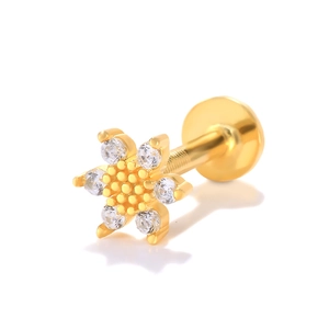 Macro view of gold flower cartilage stud with clear crystals and flat back screw