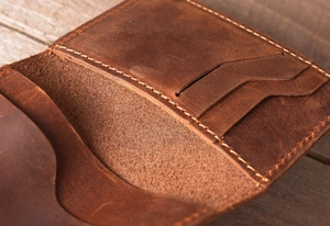 Macro shot of crazy horse leather card holder featuring rustic texture and stitching