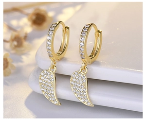 Detail of gold-plated leaf drop earrings with sparkling white cubic zirconia pavé