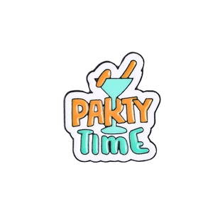 Detail of cocktail glass enamel pin with Party Time text and orange fruit accents