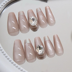 Cat eye nude pink press-on nails in coffin shape with elegant oval diamond accents