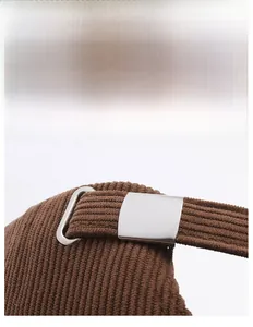 Detail of adjustable metal buckle and corduroy strap on back of the baseball cap