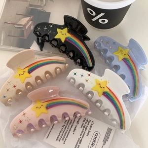 Set of colorful acetate hair claws with rainbow and star patterns and embedded rhinestones