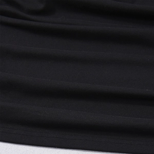 Close-up of black knitted top featuring detailed double-needle hem stitching and texture