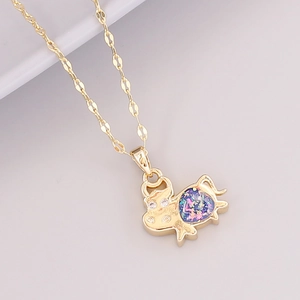 Detail of 18K gold ox pendant necklace with colorful sparkling inlay and crystal accents