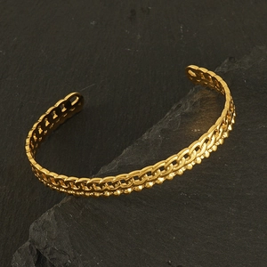 Classic French retro gold stainless steel chain cuff bracelet on stone background
