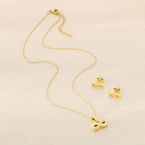 Detailed view of 18k gold plated infinity necklace and earrings set with tiny diamonds