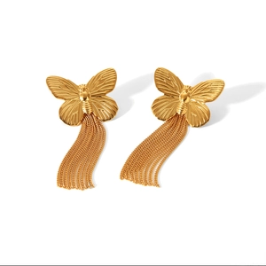 Detail of golden butterfly stud earrings with elegant long fringe tassel chains