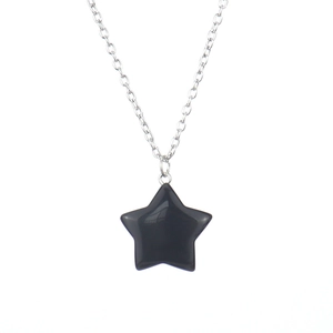 Close-up of a 2.5cm polished black onyx star pendant necklace with silver chain