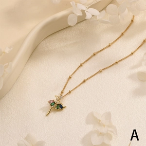 Macro detail of ballerina pendant necklace with multi-colored zircons on silk background