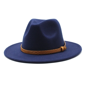 Detail of navy blue wool fedora featuring a brown snakeskin texture leather band and buckle