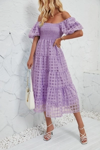 Detail of lavender checkered fabric on flowy tiered summer dress with puff sleeves