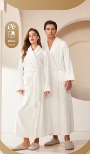 Detail of white flannel bathrobe featuring textured cuffs and a minimalist waist tie belt