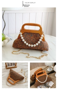 Detail of multicolor brown tweed bag with wooden handle and large pearl chain decoration