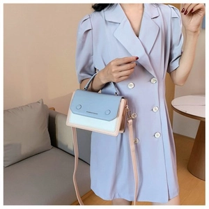 Three-color contrast stitching square crossbody bag shown on a model in a lifestyle setting