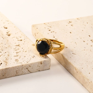 Detail of 18K gold plated titanium ring featuring a black zircon and hollow band design