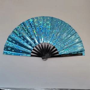 Detail view of blue holographic laser fan with black bamboo ribs and honeycomb pattern